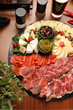 Cheese and cold cuts board, tapas. Buffet with tasty meat snacks, pickles, top view.
