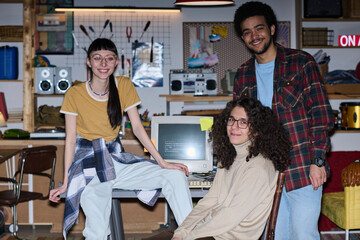 Portrait of young startups smiling at camera while working over new project in team