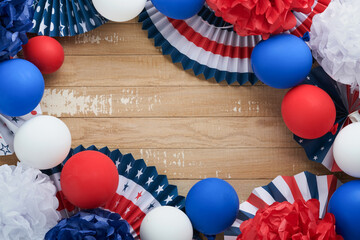 4th of July background. USA paper fans, Red, blue, white stars,  balloons, gold confetti on white wooden  background. Happy Labor Day, Independence or Presidents Day. American flag colors. Top view.