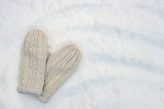 Wall Mural - warm knitted mittens on white fluffy snow, I love winter concept, free space for text