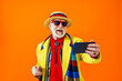 Cool senior man with fashionable outfit portrait - Old and funny grandfather wearing stylish and colorful clothing portrait on colored background