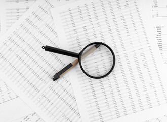 Poster - Pen and magnifying glass on financial statement.
