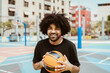 Happy man playing basketball outdoor - Urban sport lifestyle concept
