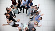 © Katsiaryna - Close up top view of young people putting their hands together.