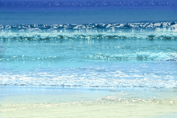 Background of colorful ocean waves sparkling in evening sun