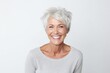 Portrait of a happy senior woman smiling at the camera over white background