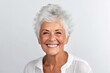 Portrait of a happy senior woman smiling at the camera against white background