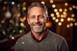© Robert MEYNER - Portrait of a smiling middle-aged man in a Christmas decorated room.