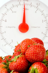 Wall Mural - Fresh Strawberrys and wieght scales set against a plain background