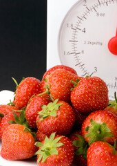 Wall Mural - Fresh Strawberrys and wieght scales set against a plain background