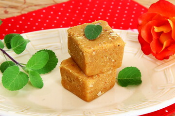 Indian traditional home made Sweet besan burfi Also Known in india as burfi,magas,mohanthal or halwa for offering to god as prasad in hindu religion