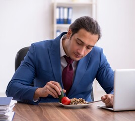 Wall Mural - Young businessman working in the office