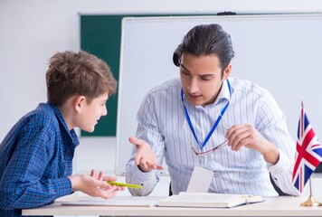 Wall Mural - Male english teacher and boy in the classroom