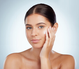 Poster - Skincare, face and beauty of woman with lotion in studio isolated on a white background. Portrait, dermatology cream and female model apply cosmetics, sunscreen or moisturizer product for skin health