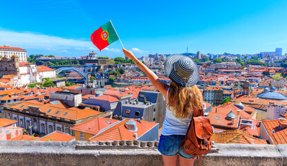 Wall Mural - porto travel destination- woman with portuguese flag enjoying panoramic view of city landscape of op