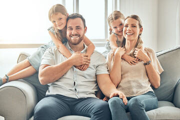 Canvas Print - Portrait of mom, dad and children on sofa in living room for bonding, quality time and relax together. Happy family, smile and parents hugging girls for care, love and support at home on weekend