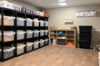 a room full of storage bins, labeled and organized, created with generative ai