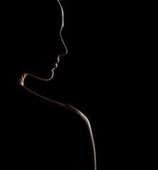 Wall Mural - Sensual portrait silhouette of beautiful woman in backlight on a black background