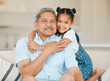Family, grandfather and grandchild hug with smile in portrait, happiness and bonding at home. Love, care and trust with elderly man and happy young child with embrace, affection and living room couch