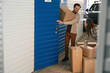© Viacheslav Yakobchuk - Young man and woman with big cardboard boxes in self storage unit