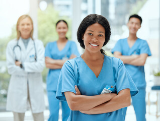 Poster - Portrait, medicine and a black woman nurse arms crossed, standing with her team in a hospital for healthcare. Leadership, teamwork and a female health professional in a medical clinic for treatment