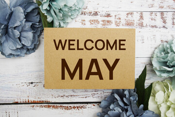 Poster - Welcome May text message with flower decoration on wooden background