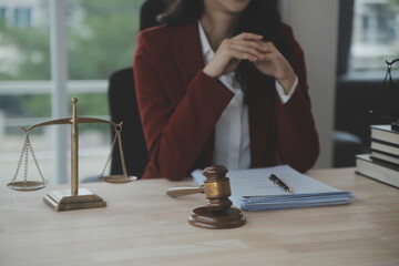 Justice and law concept.Male judge in a courtroom with the gavel, working with, computer and docking keyboard, eyeglasses, on table in morning light