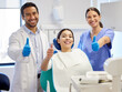 © L Ismail/peopleimages.com - Dentist team, patient and thumbs up portrait for.consultation, clean or teeth whitening. Woman, asian man or healthcare staff and client together for dental care, oral health exam and mouth cleaning