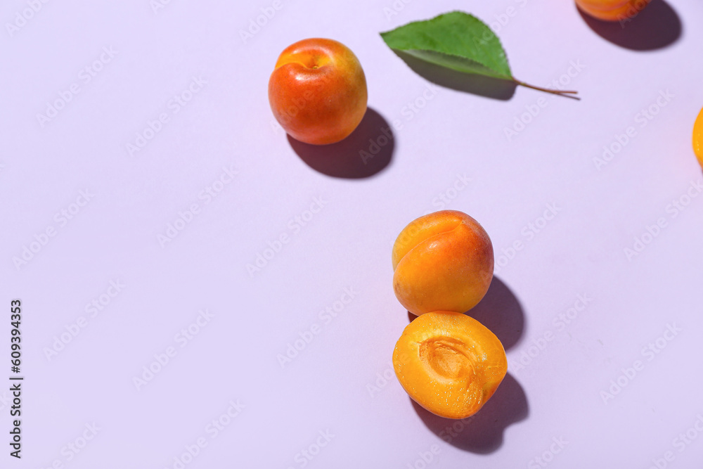 Fresh apricots with leaf on lilac background