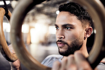 Poster - Athlete man, gymnastic rings and gym for a training workout with focus and commitment. Face of serious male person with pull up exercise for strong muscle, power and fitness training with balance