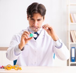 Wall Mural - Young handsome doctor oculist working at the clinic