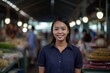 Portrait of a young asian woman standing in front of a market stall