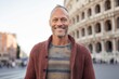 Portrait of smiling mature man standing in front of Colosseum in Rome, Italy