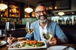 © Anne-Marie Albrecht - Medium shot portrait photography of a cheerful man in his 40s that is wearing a chic cardigan against a beautifully plated gourmet meal being served background . Generative AI