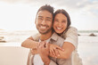 © Azeemud-Deen Jacobs/peopleimages.com - Portrait, hug and couple at the beach with happiness for a vacation in the summer having fun. Together, hugs and ocean for holiday with smile for the weekend with sunshine for relaxing and bonding.