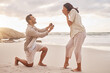 Couple, engagement proposal and surprise at beach with smile, happiness or love on vacation in sunset. Man, woman and ring with marriage offer by ocean with smile, excited face or together on holiday