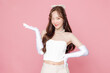 Young Asian beautiful woman Curly long hair with korean makeup style on face and clear smooth skin showing open hand palm on isolated pink background. Facial treatment, Cosmetology, plastic surgery.