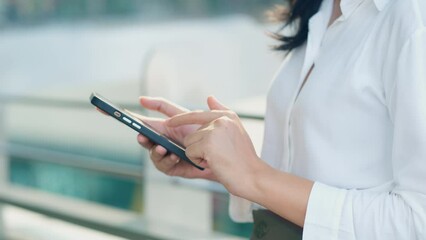 Close up on business woman using smart phone for reading message and texting on communication application, social media, remote work and online lifestyle concept.