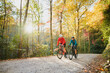 © Andrew Kornylak - A couple gravel biking near Blue Ridge Parkway in autumn, Pisgah North Carolina