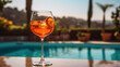aperol spritz with a pool in the background