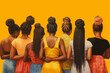 © World of AI - A group of women of color from the back with diverse hair styles like corn rows, dread locks and weaves wearing bright clothes on a yellow background created using AI generative technology