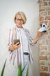 © Miljan Živković - woman mature caucasian hold adjust home security camera and smartphone