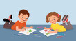 © Tenstudio - Cute little kids drawing painting together lying on the floor