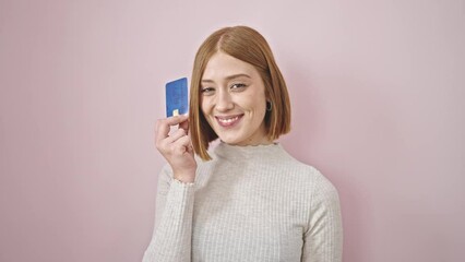 Sticker - Young blonde woman smiling confident holding credit card over isolated pink background