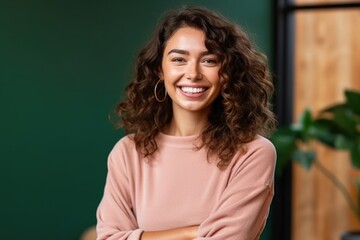 Happy young smiling confident professional business woman wearing a sweater, pretty stylish female executive looking at camera, standing arms crossed , Generative AI