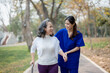 © Jirapong - Patient care, female care, young Asian women are taking care of the elderly, providing crutches and walking for patients, and exercising their legs and knees in the park parks.