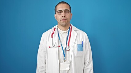 Canvas Print - Young hispanic man saying no with finger over isolated blue background