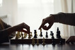 © alexkich - Hand playing game of chess, competition, strategy, battle, play