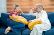 Family members of two generations grown daughter and mature father having fun enjoy talk on cozy couch. Attentive young lady caregiver social worker visit support care for glad elderly man patient