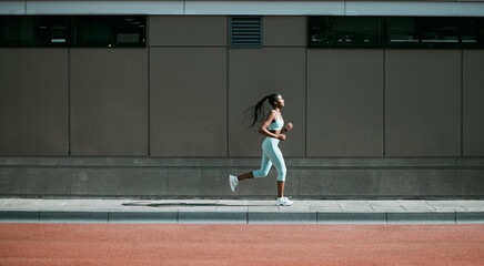 black woman, running and city sport on sidewalk with training, exercise and fitness on road. street,
